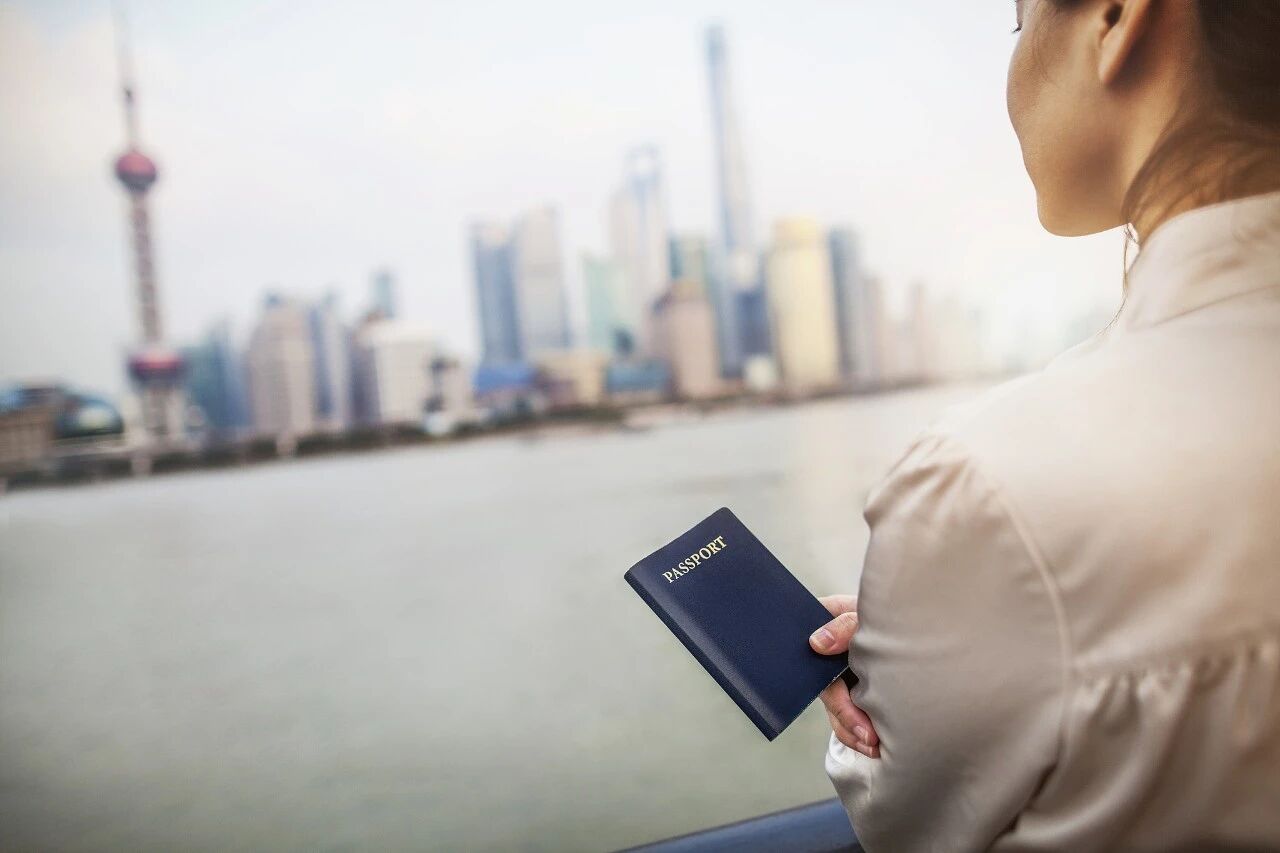 What should I do with my residence permit if I renew my passport?